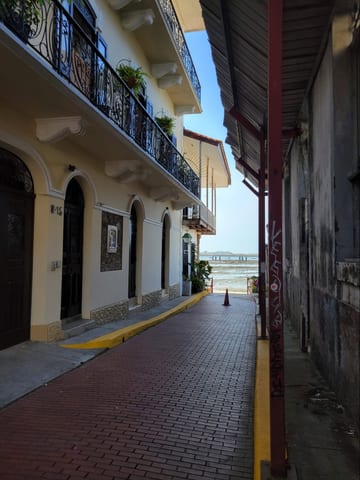 A narrow Casco Viejo alleyway leading toward the Pacific