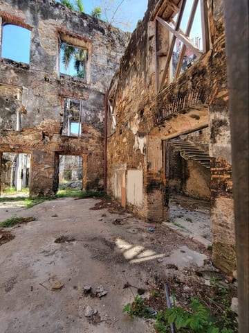The interior of a roofless stone building with weathered walls