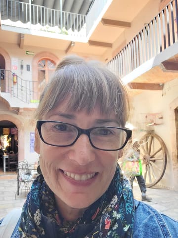 Stacy smiling in the courtyard after having her bangs trimmed