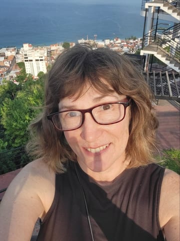 Stacy smiling at the Puerto Vallarta mirador with the ocean behind her